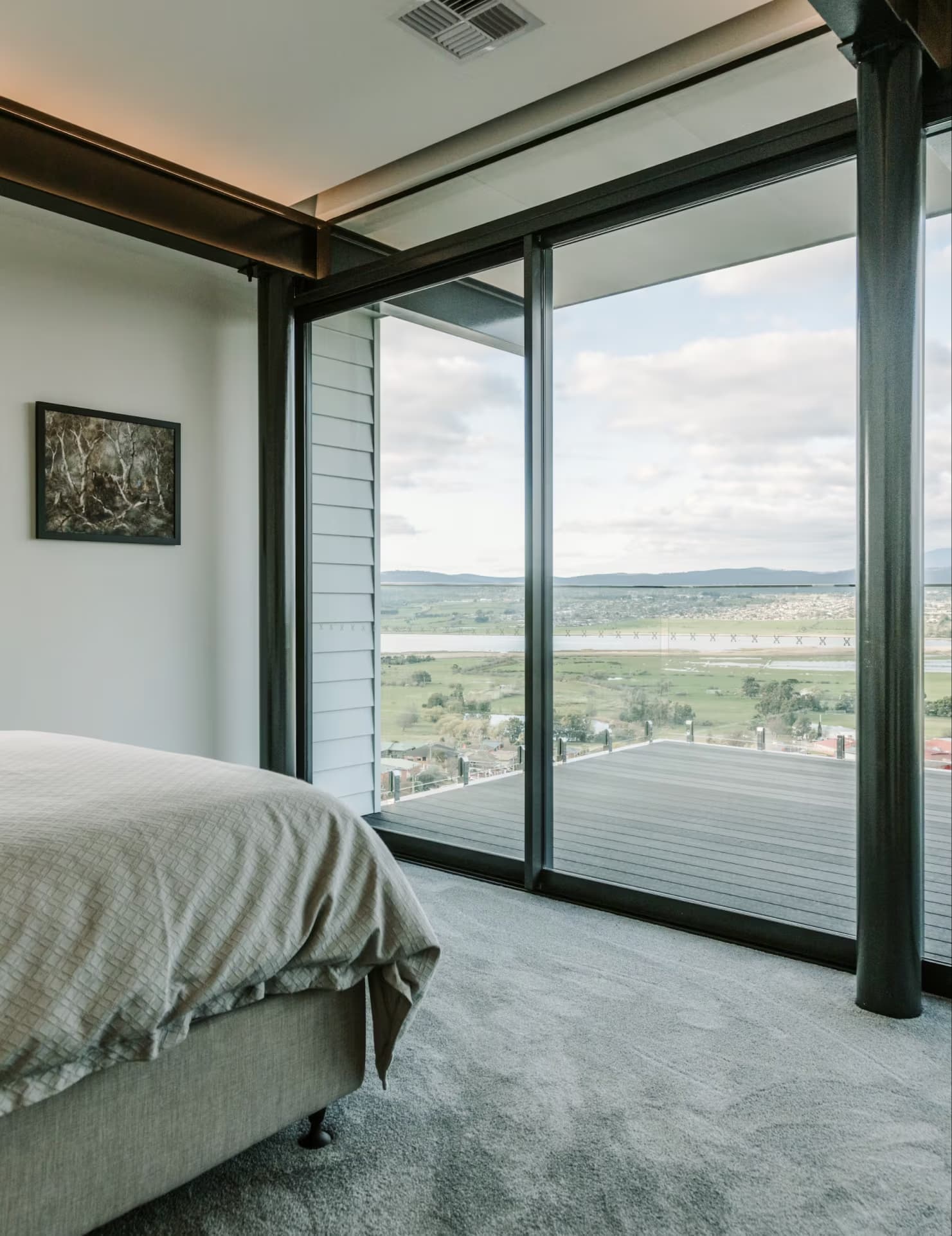 Image of a glass door in a bedroom with a view of greenery