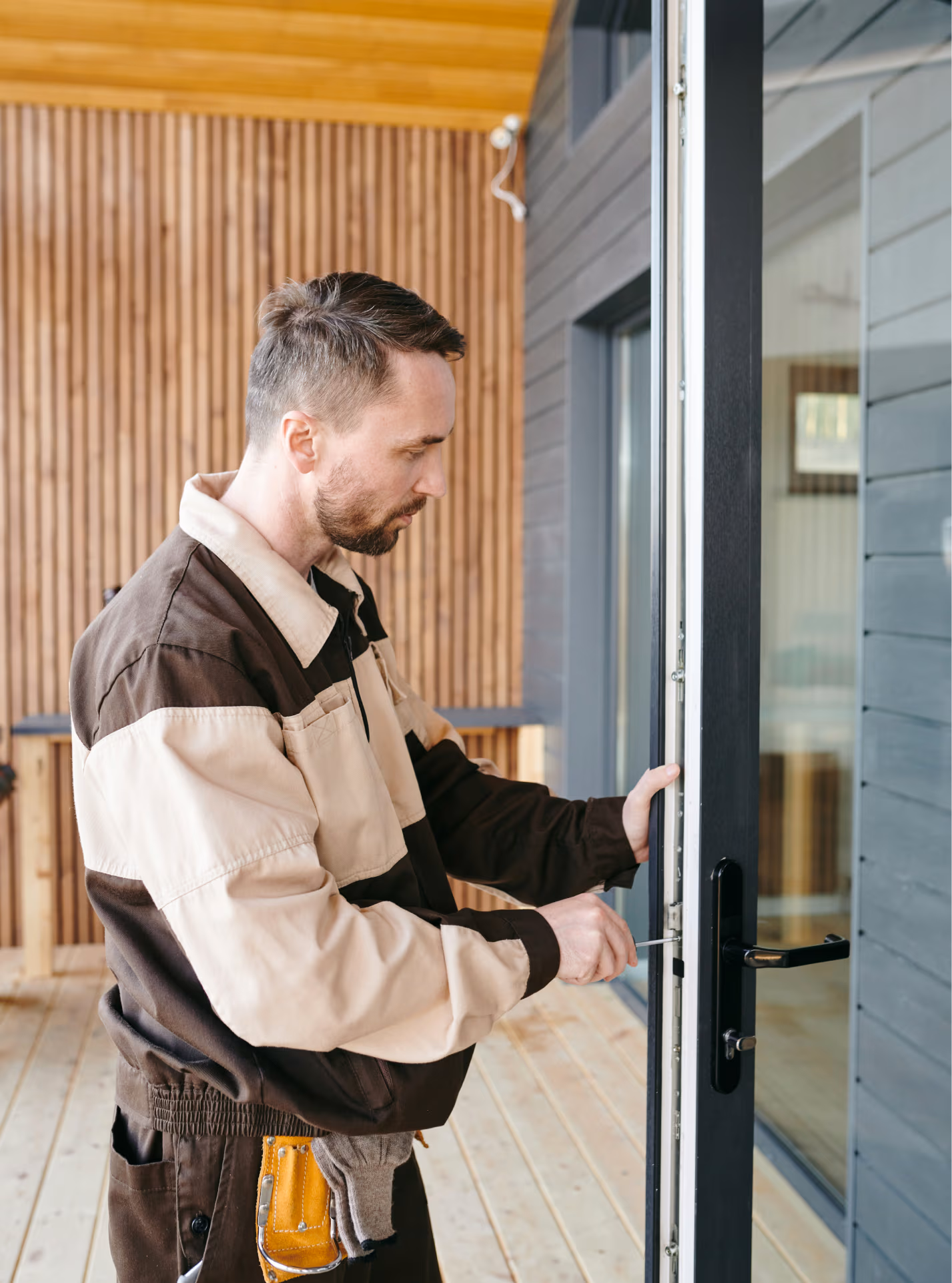 A professional glazier repairing a glass door
